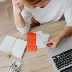 Woman struggling to calculate revenue through managing bills