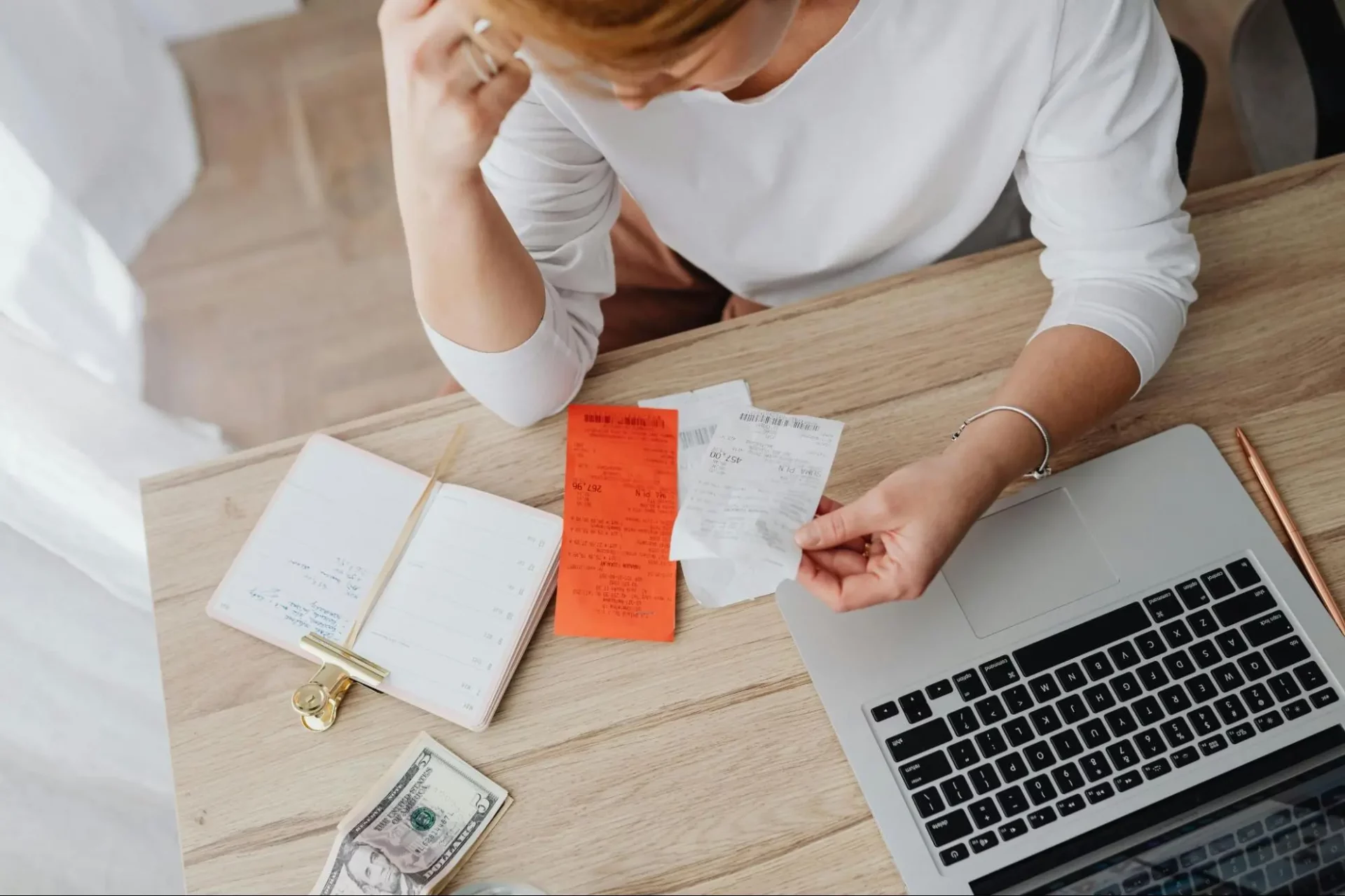 Woman struggling to calculate revenue through managing bills