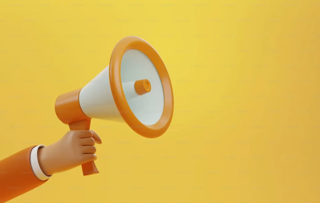  a man holding a cone speaker