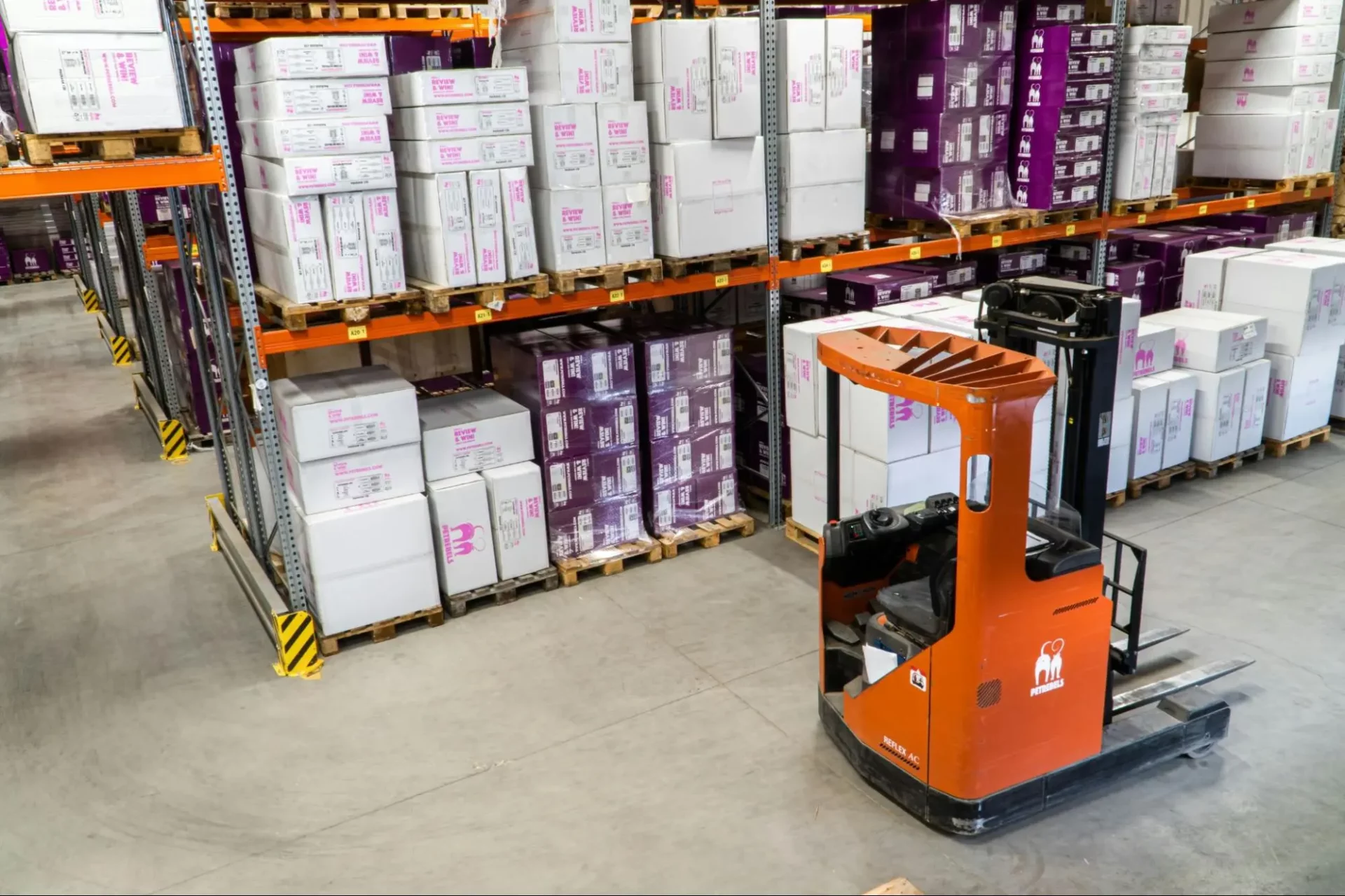 Workers operating a reach truck in a warehouse