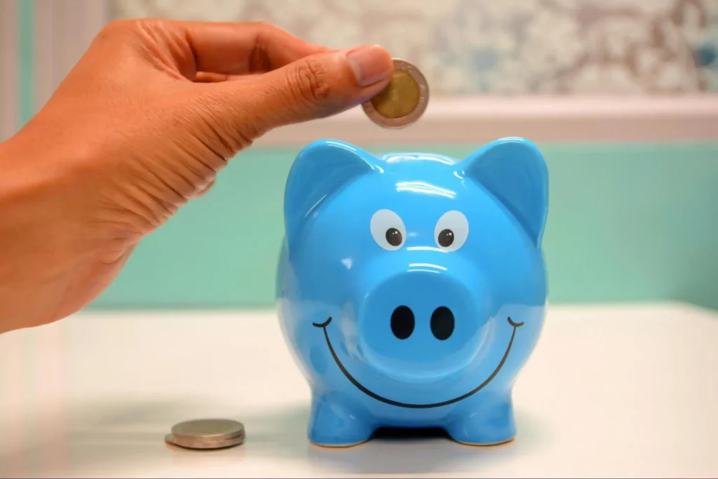 Man saving some money using a piggy bank