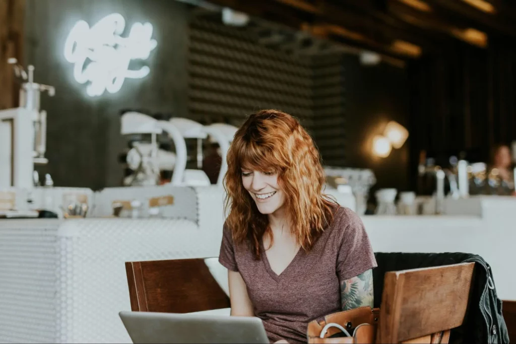 Women smiling in front of laptop