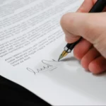 Person signing in a document