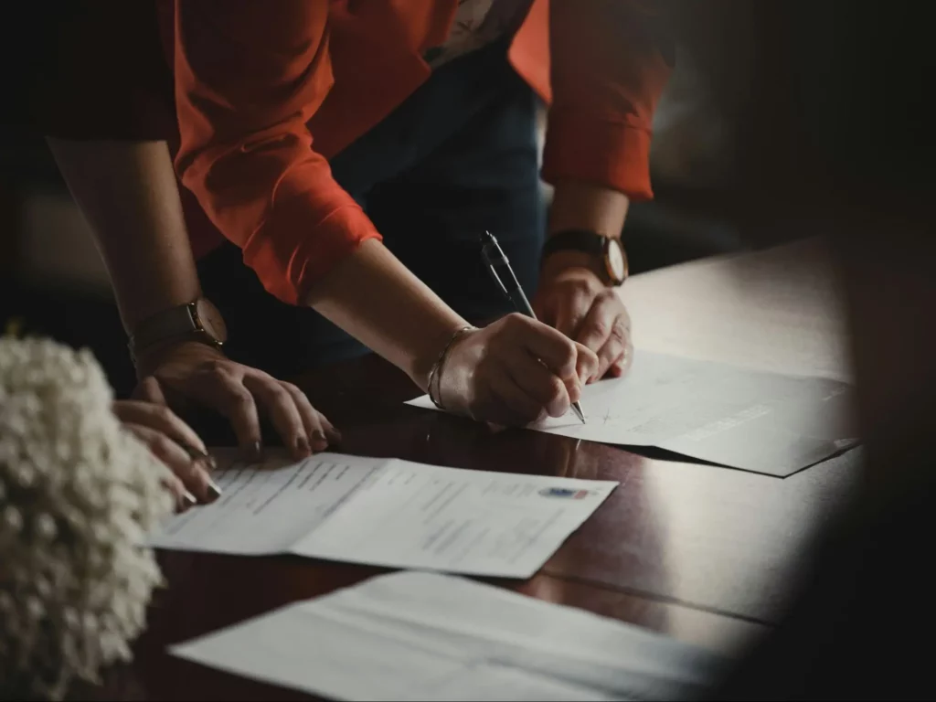 person signing in a document