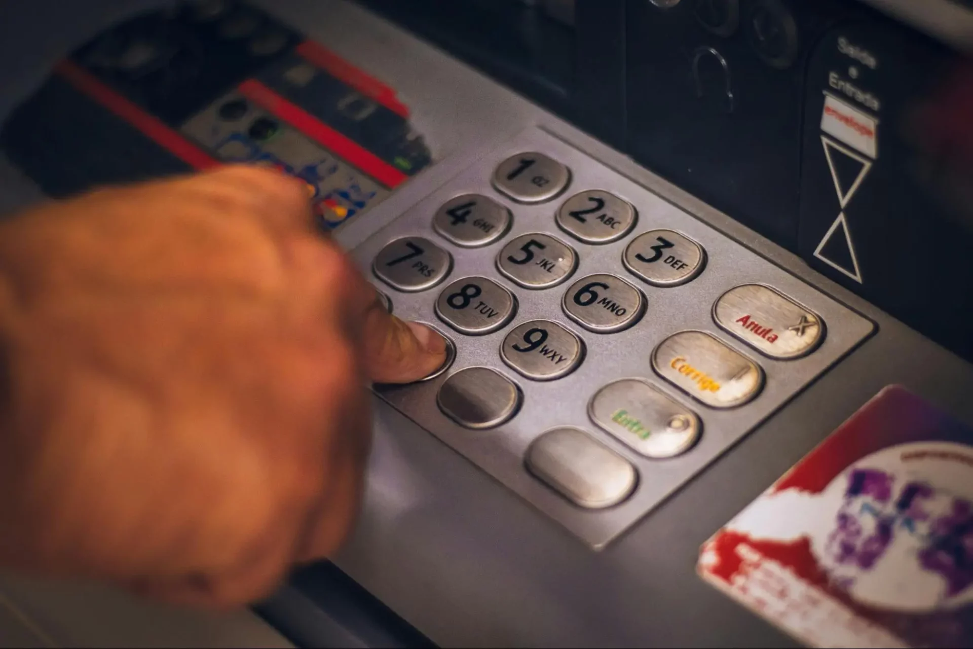 Man pressing a button in ATM