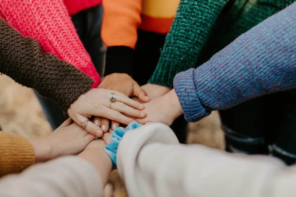 people keeping hands above each other