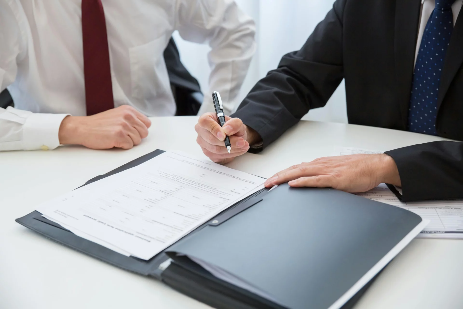 man signing a contract