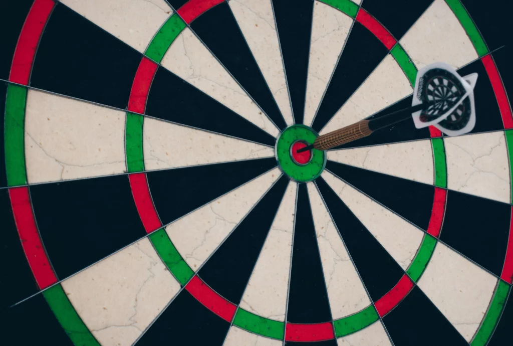 A dart in bull's eye close up.