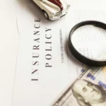 Magnifying glass on insurance policy document