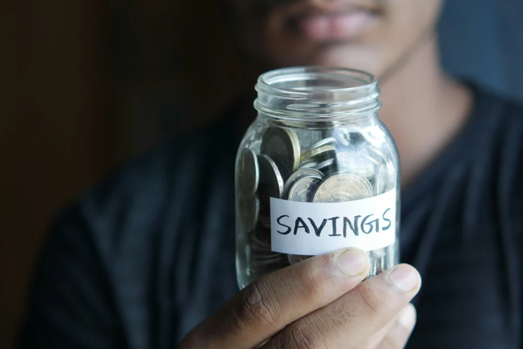 Coins kept in a jar labeled savings