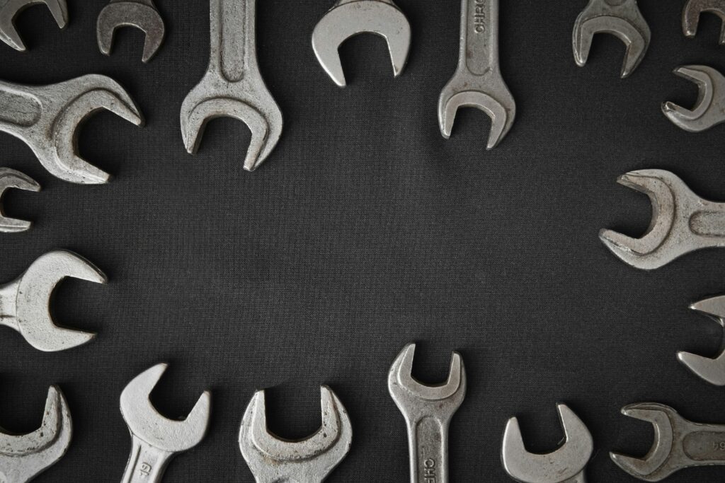 various mechanic tools placed above black table