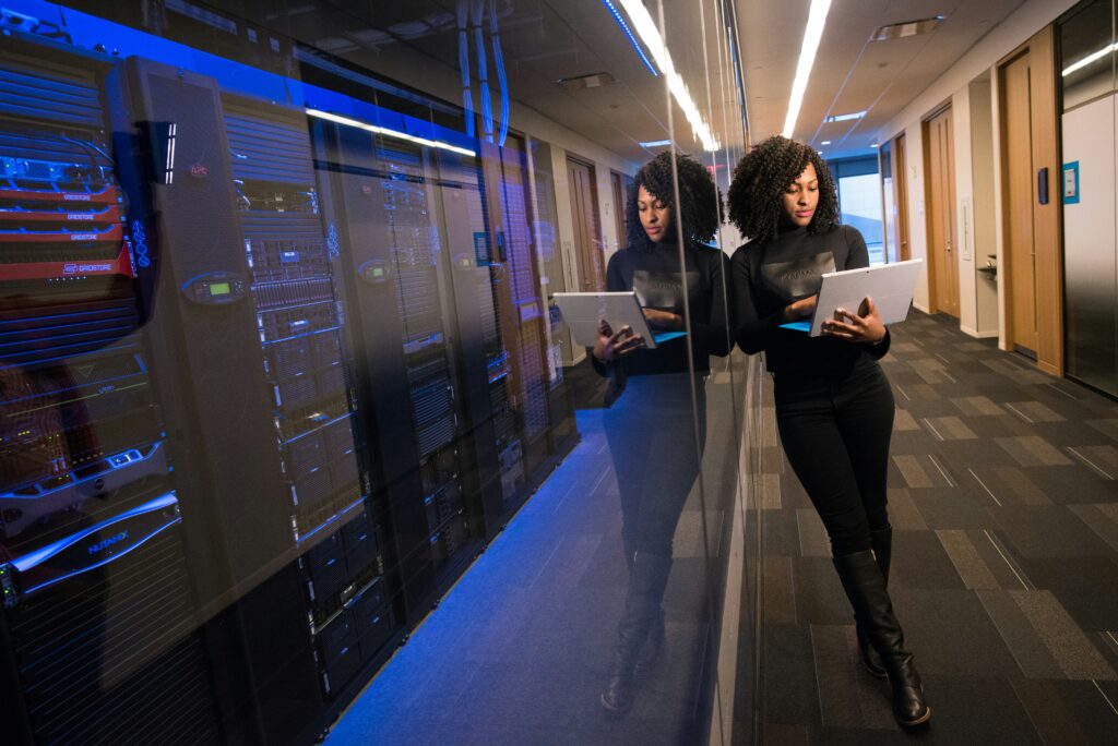 Woman carrying her laptop in the data center