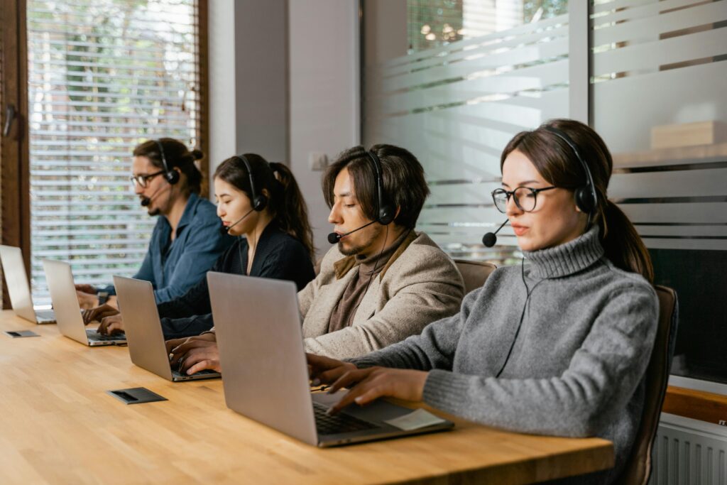 Employees working on their laptops and providing customer support 