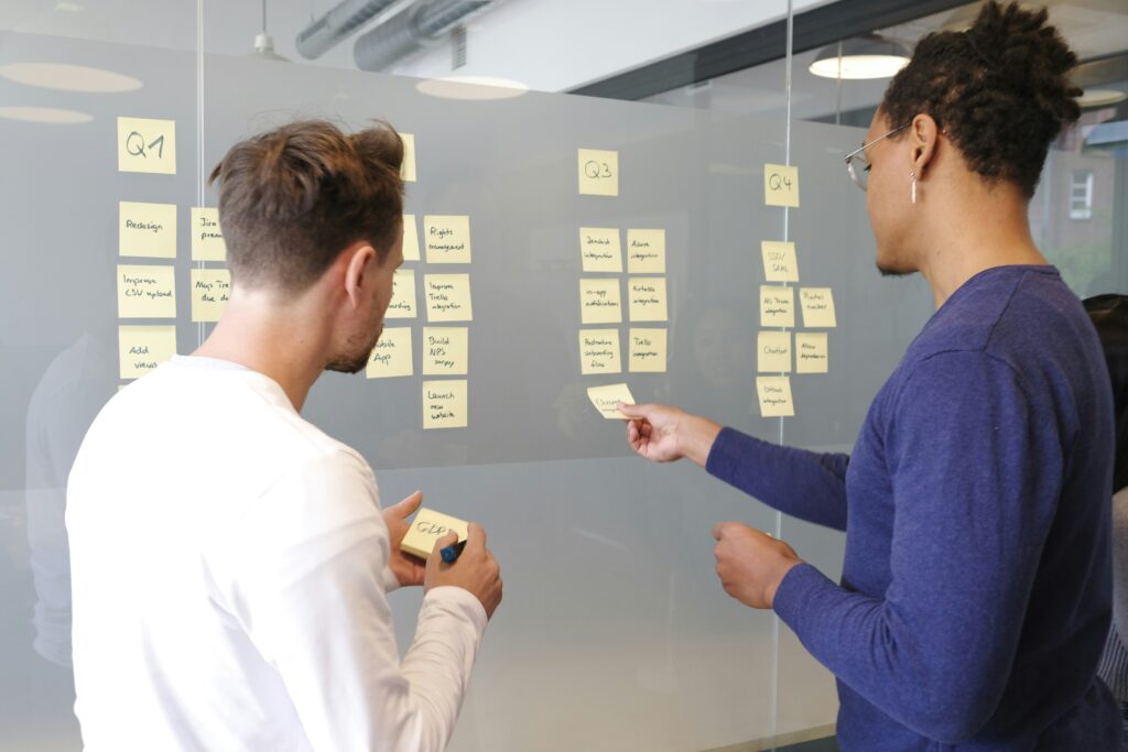 Employees pasting sticky notes on the wall